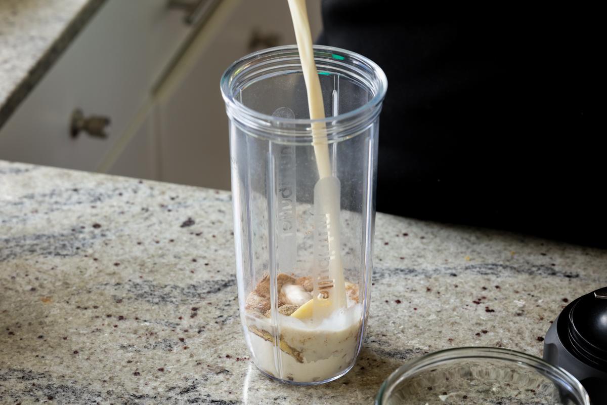 adding masala ingredients to the blender
