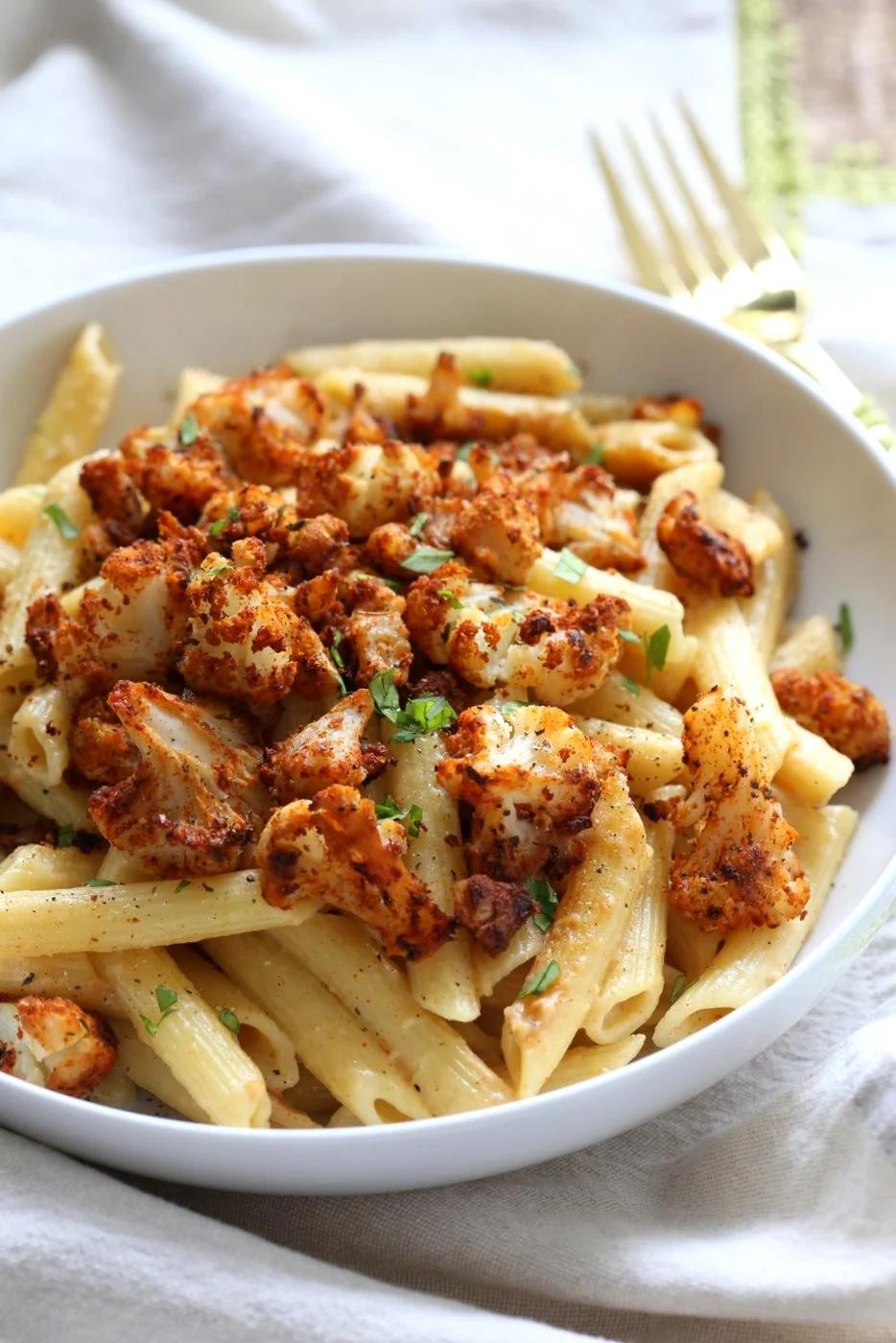 Vegan Garlic Pasta with Roasted Cajun Cauliflower. Cauliflower is tossed in homemade cajun spice blend and baked, then served over easy creamy Garlic sauce Penne Pasta. Vegan Recipe. Can be Nut-free gluten-free | VeganRicha.com