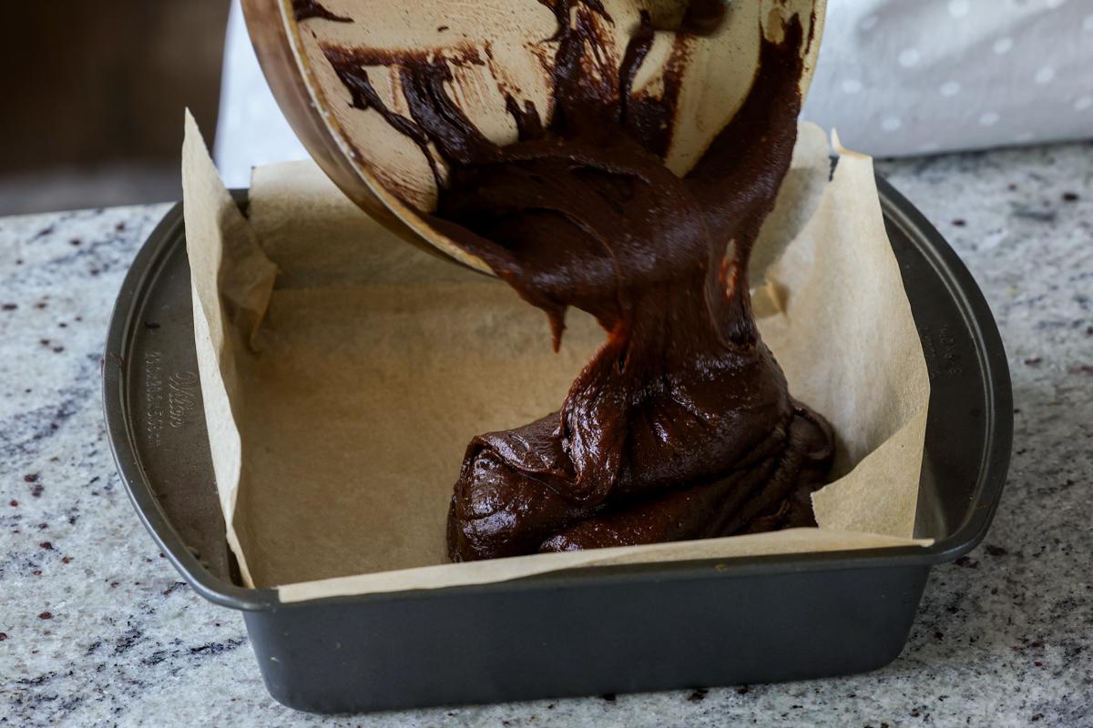 pouring the batter into the brownie pan