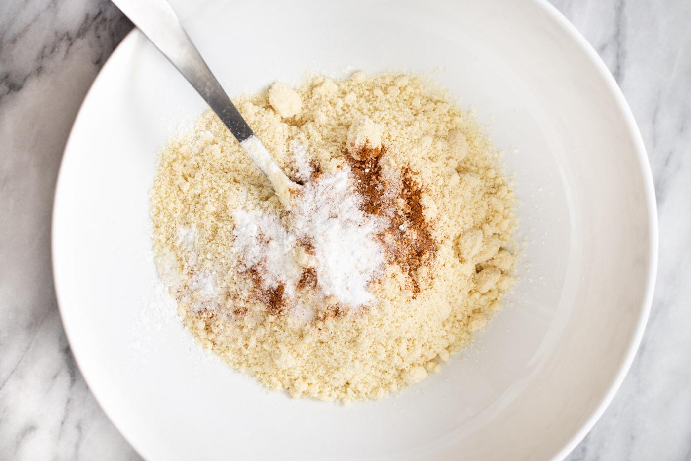 dry ingredients for vegan snickerdoodles in a white bowl