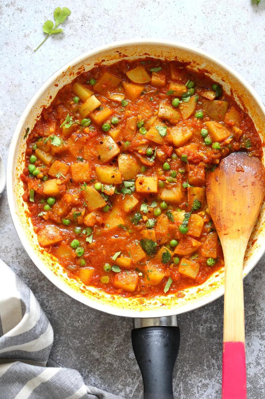 overhead shot of Vegan Aloo Matar with potatoes and peas in a skillet