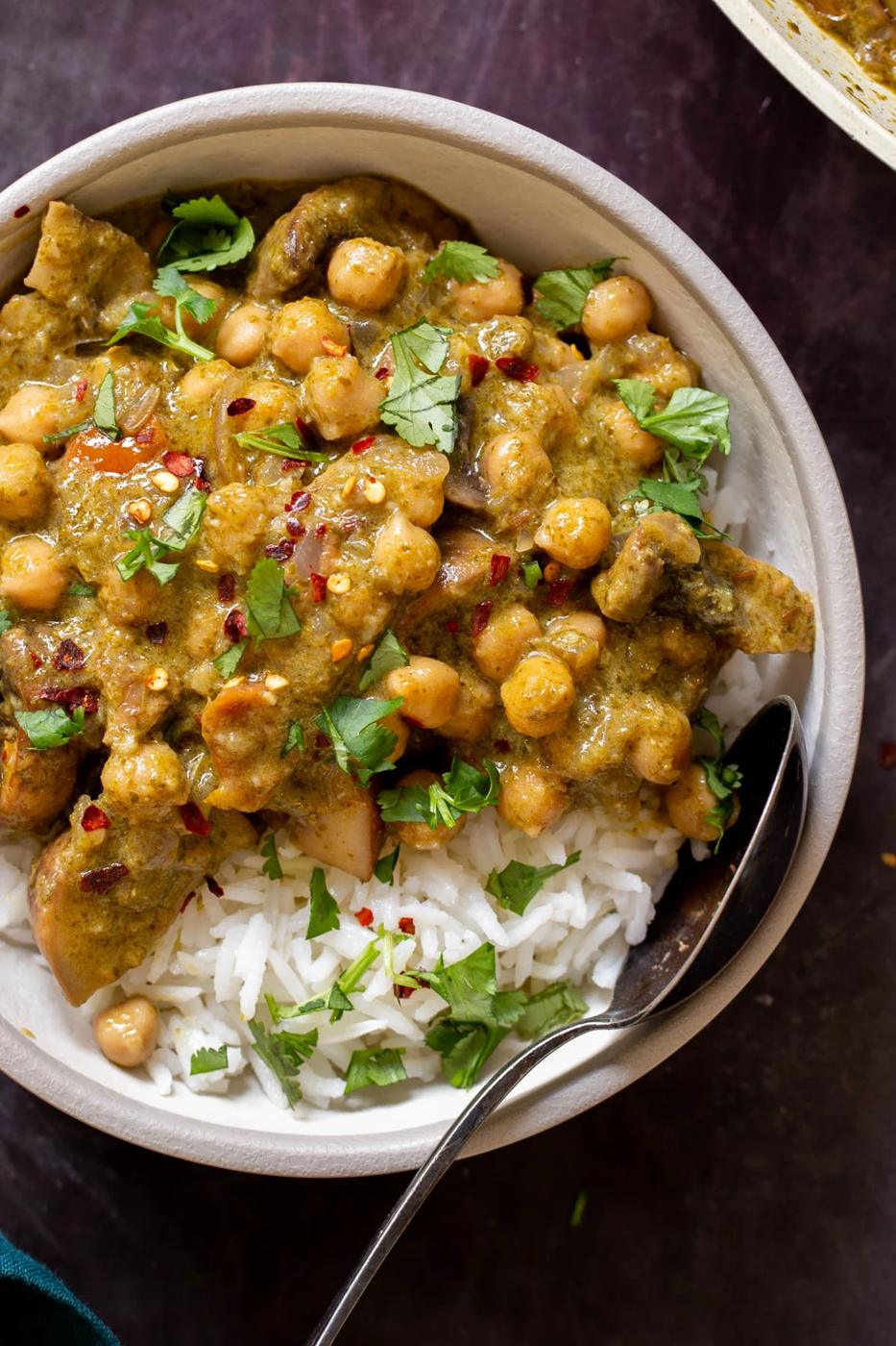 close-up of Andhra green chili chickpeas in a bowl with rice and cilantro