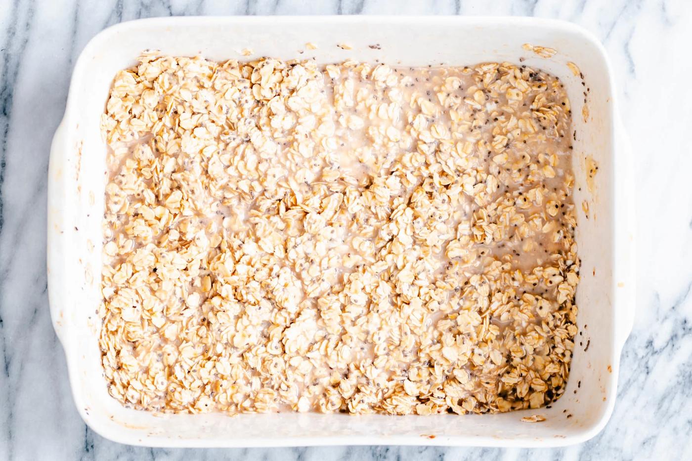 oatmeal and chia seeds soaking in a casserole dish