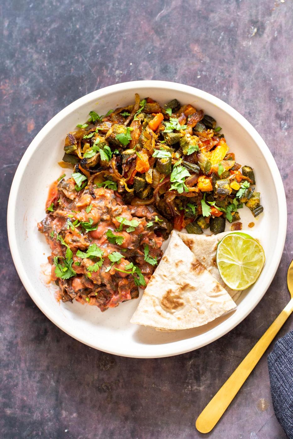 plate filled with bhindi okra curry and another Indian veggie curry and flat bread