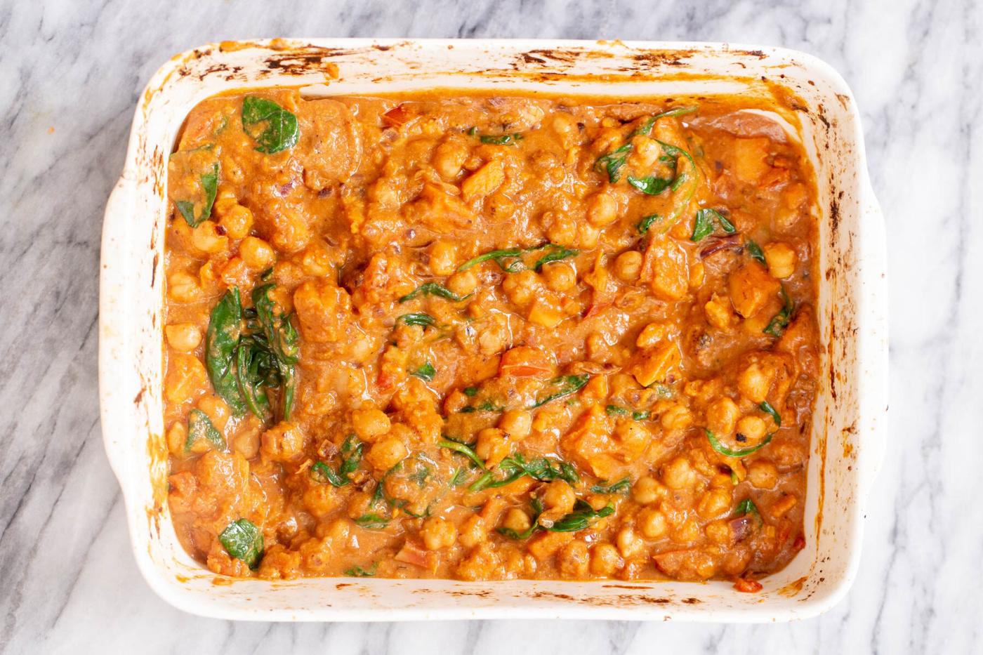 spinach being added to sweet potato chickpea curry