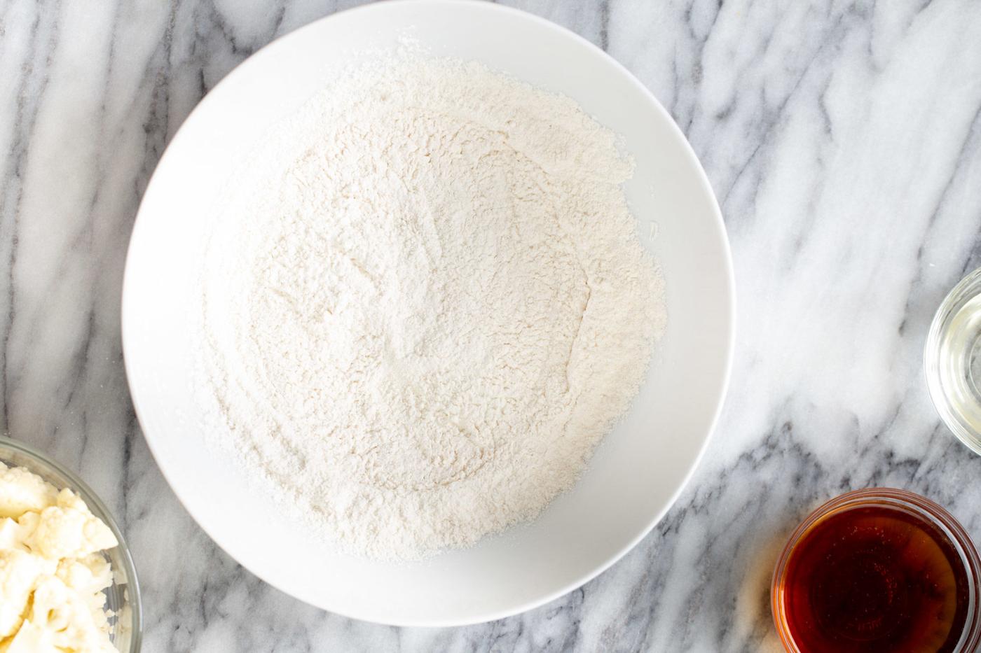 dry mix for cauliflower manchurian batter in a white bowl