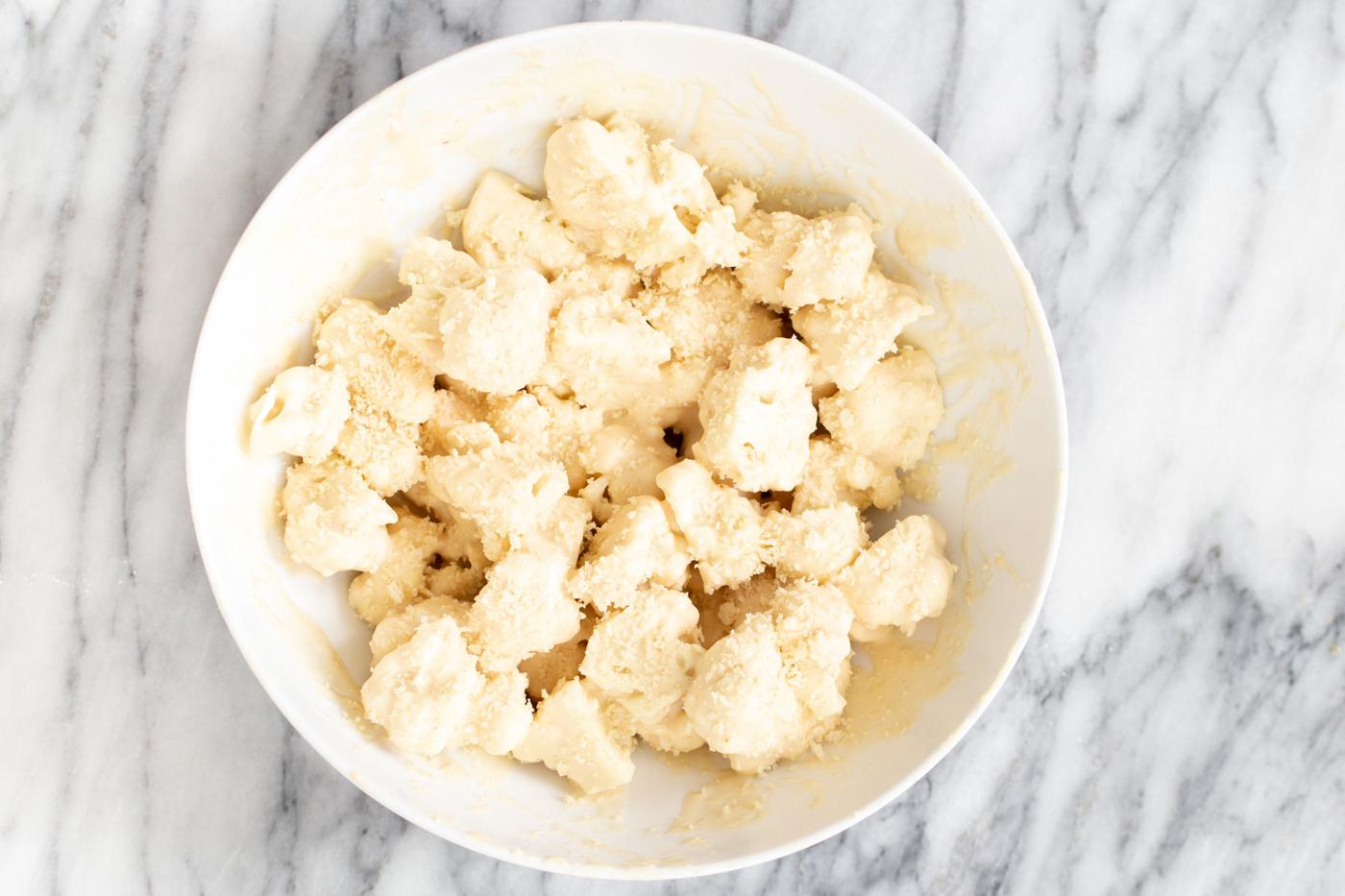 battered cauliflower florets being tossed with panko to make cauliflower manchurian