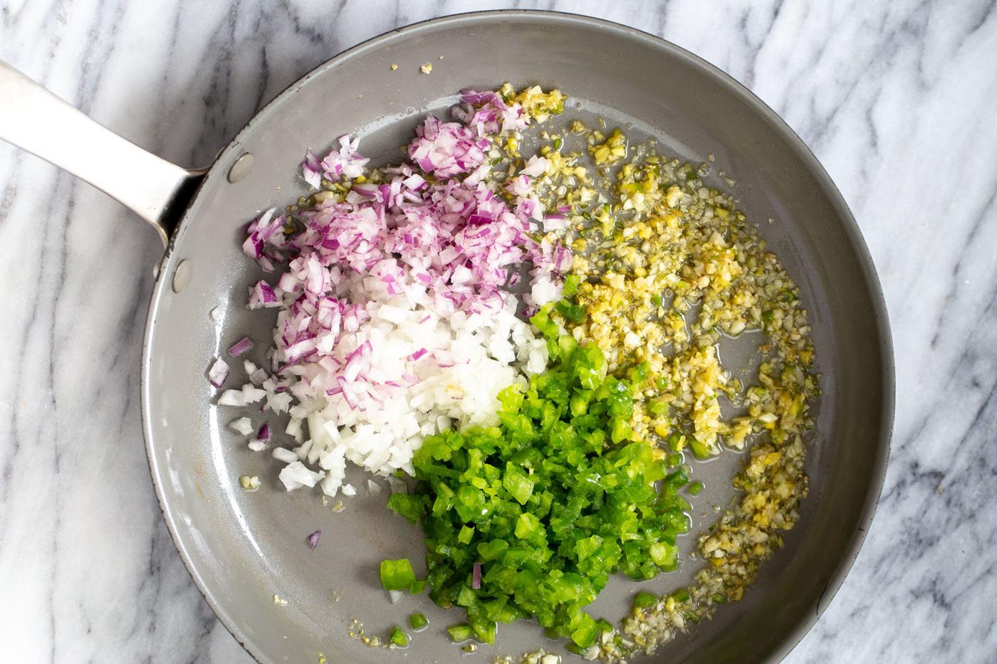 minced chili, garlic, ginger and onions in a sauteeing pan