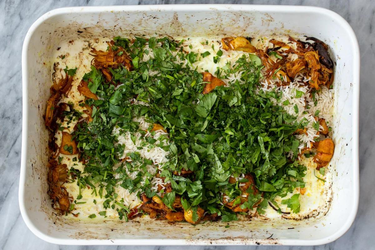 adding fresh herbs to the rice mixture