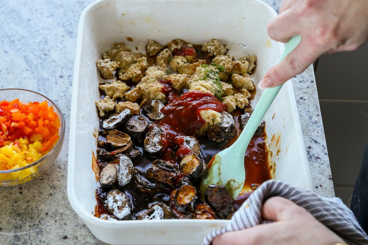 adding sauce ingredients to the pan of tofu and mushrooms