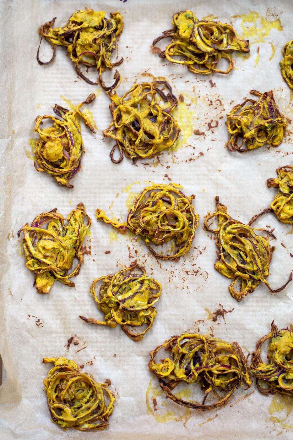 freshly baked onion pakora on a baking sheet