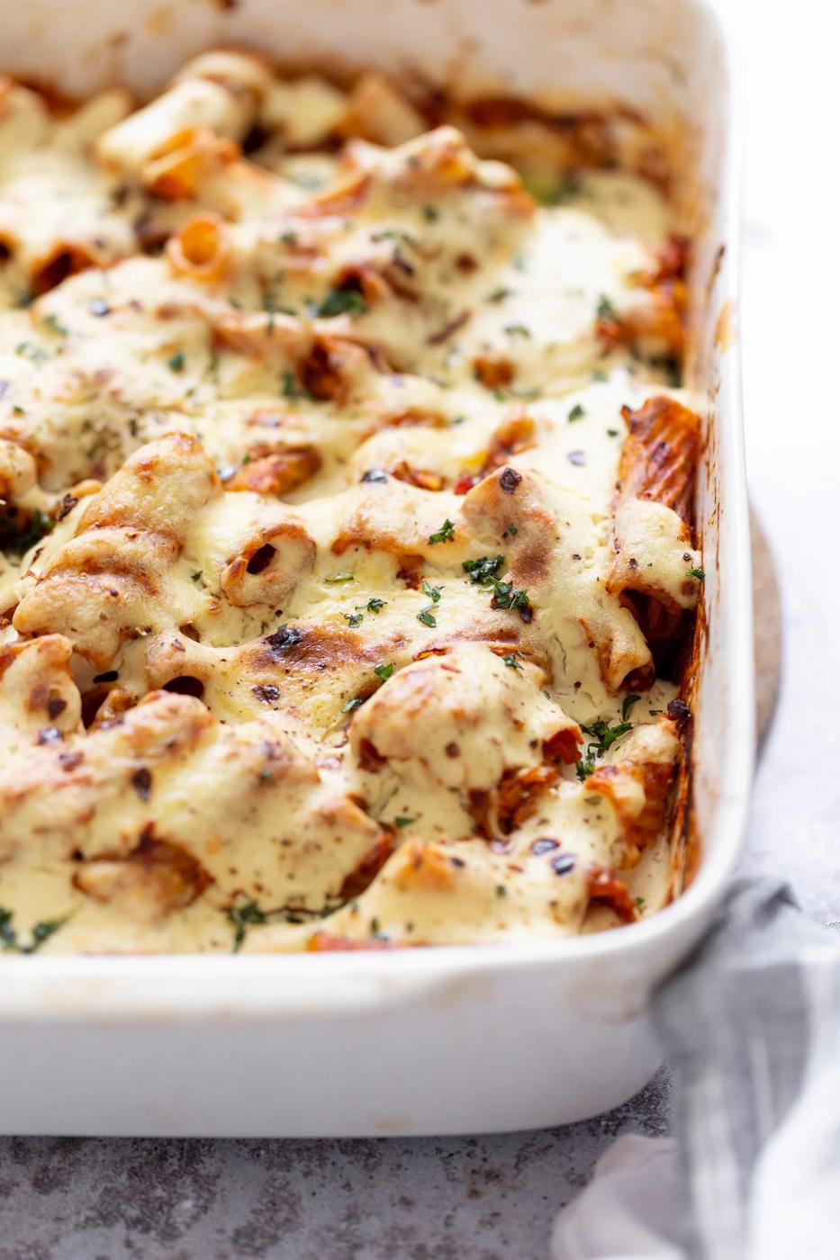 side view of a casserole dish with baked vegan rigatoni with tofu mozzarella