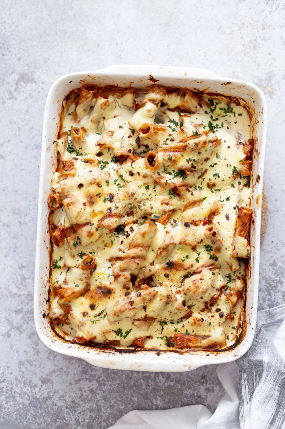 overhead shot of a casserole dish with vegan baked rigatoni with tofu mozzarella