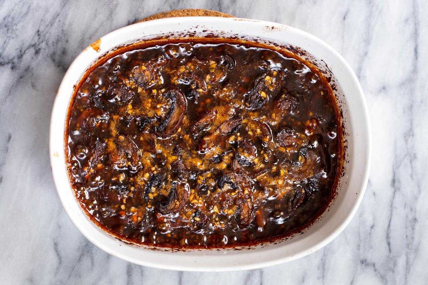 casserole dish with sliced sticky seasme mushrooms