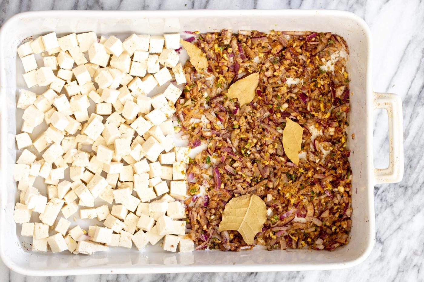 baked tofu cubes, next to minced onion ginger and chili tossed with Indian spices