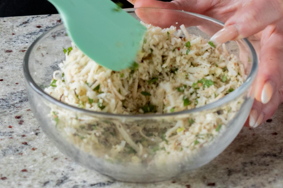 mixing breadcrumbs and seasonings into the vegan cheese shreds