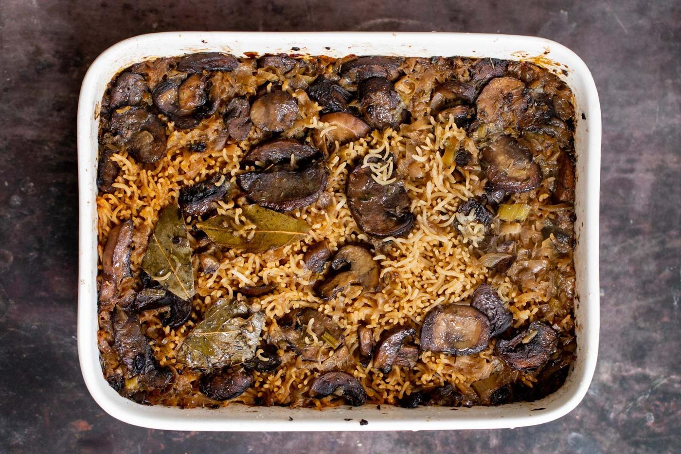 a casserole dish with baked mushroom rice