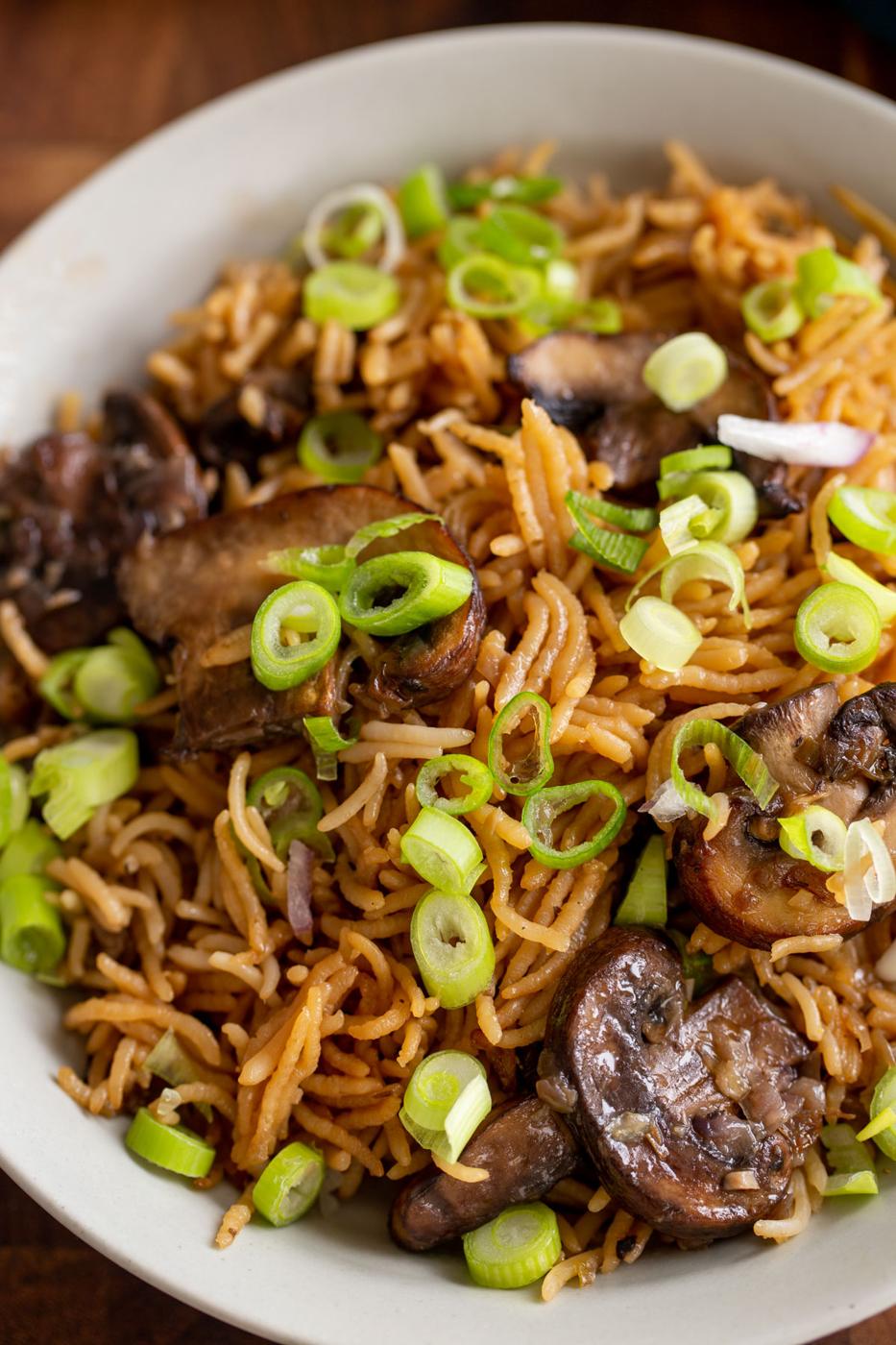 a plate of fluffy mushroom rice sprinkled with sliced green onion