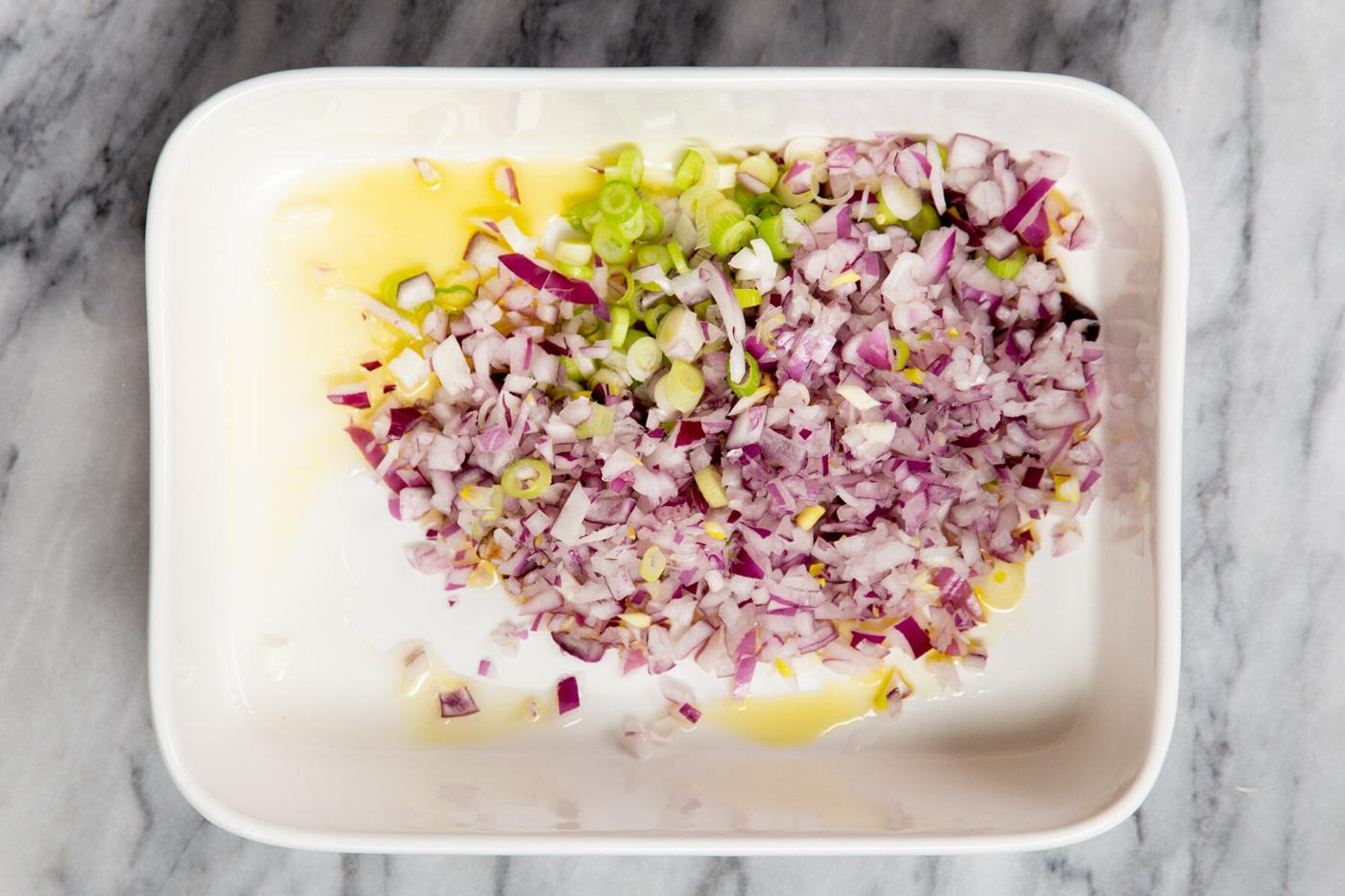 minced onion, green onion and ginger in a casserole dish