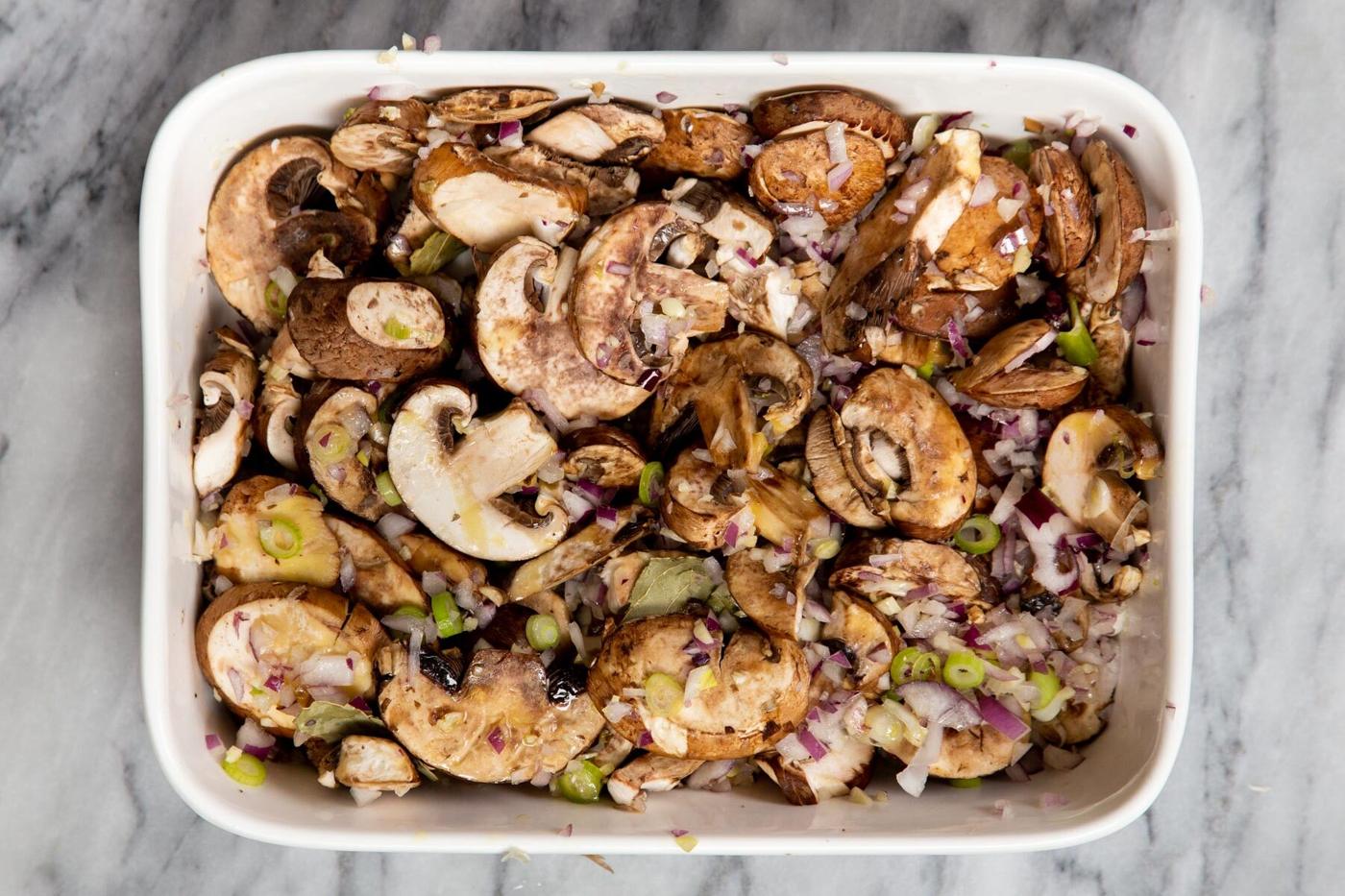 sliced mushrooms ginger and green onion in a casserole dish