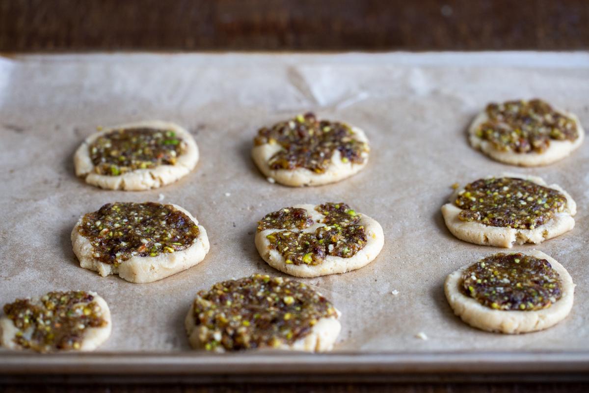 unbaked baklava cookies on a sheet of parchment paper