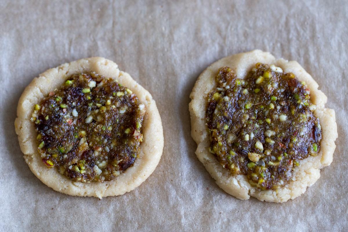 two vegan baklava cookies on a sheet of parchment paper