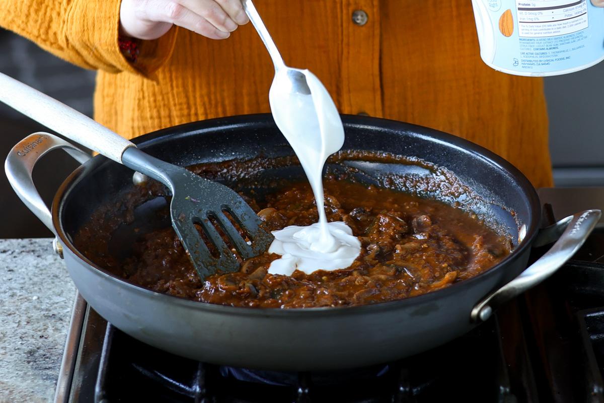 adding non-dairy yogurt to the balchao mushrooms