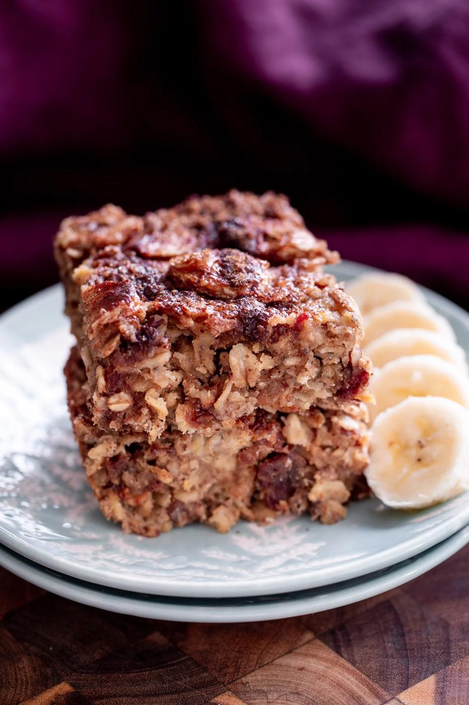 stacked vegan banana oatmeal bars on a white plate