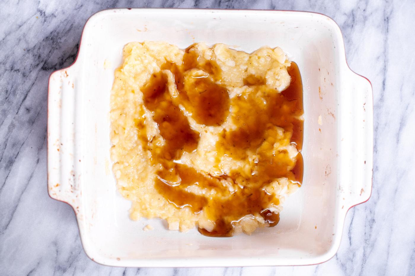 maple syrup being added to mashed bananas to make banana puree