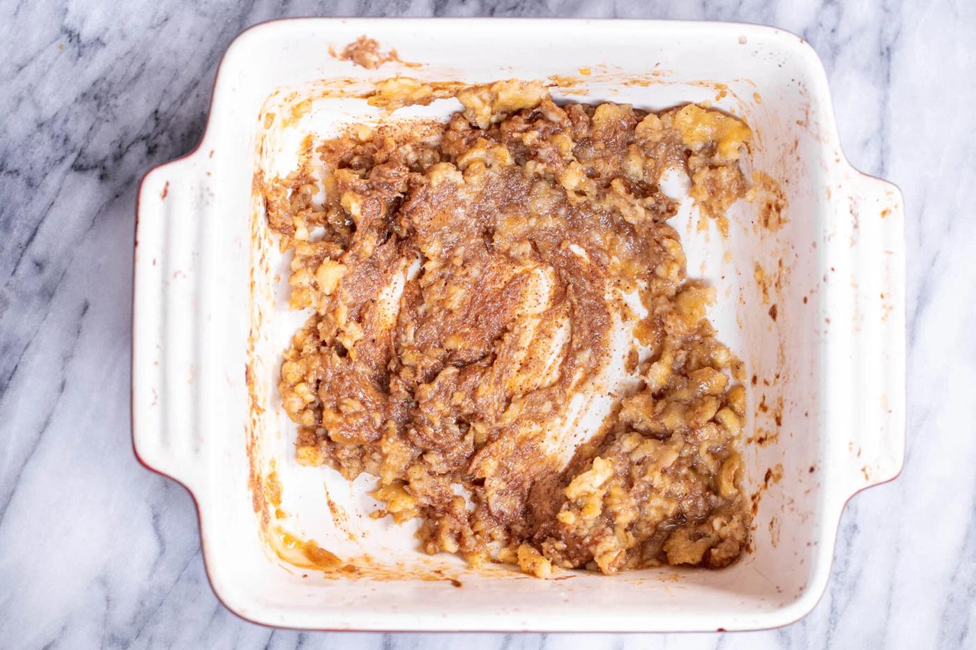 roasted banana puree being added to casserole dish