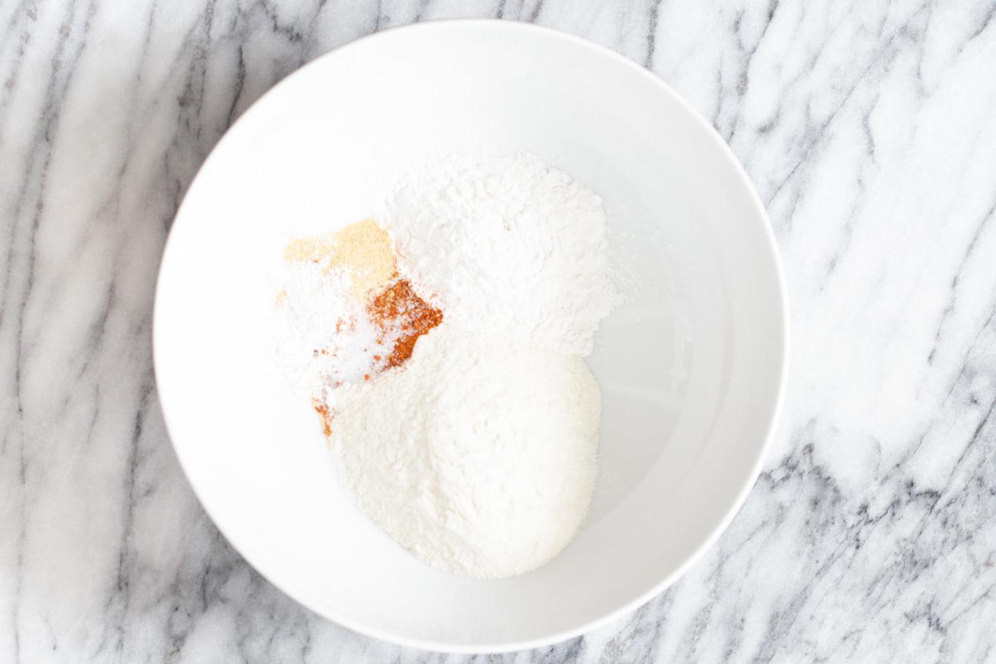 dry ingredients for vegan beer batter in a white bowl