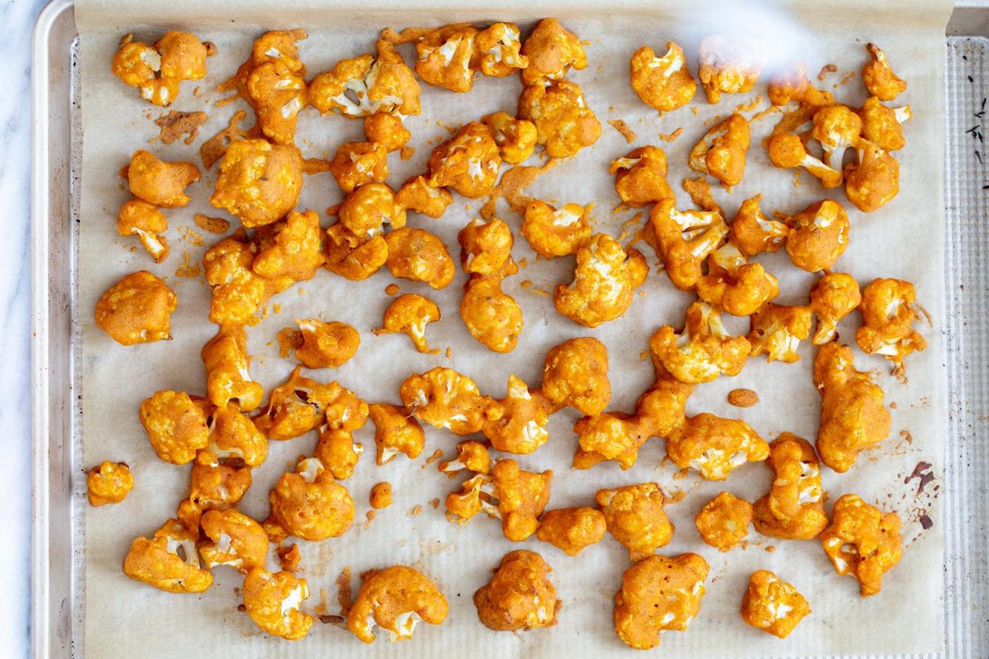 baked breaded cauliflower wings on a baking sheet