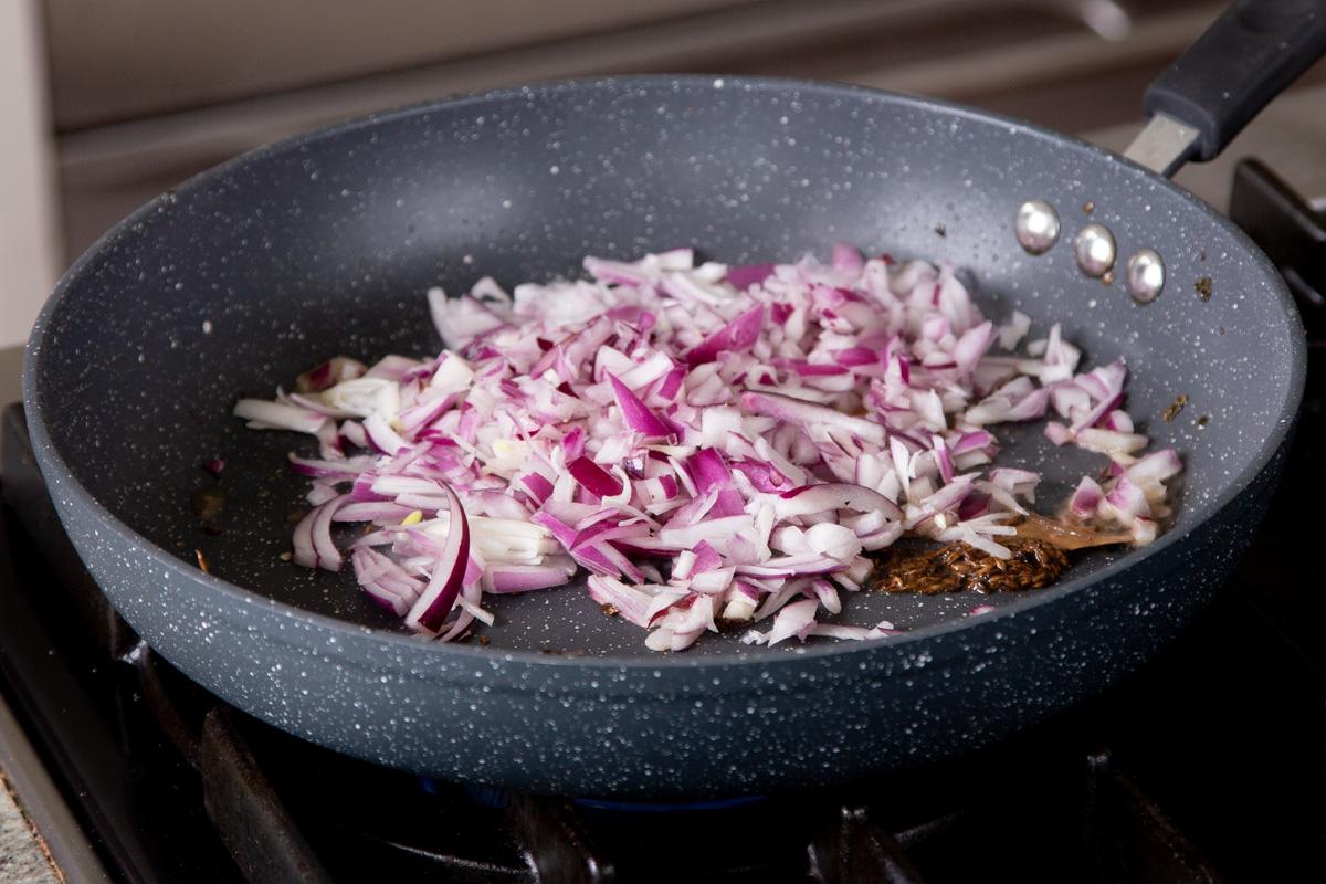 adding onion to the pan