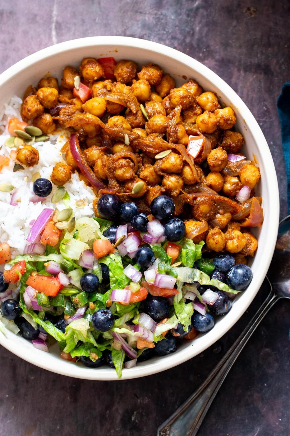 berbere spiced chickpea bowls with rice and tomato blueberry salad