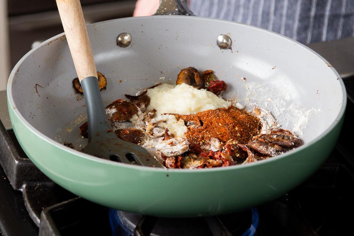 adding chili garlic paste to the pan
