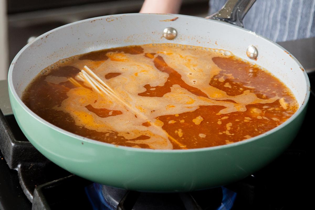 adding ramen to the birria broth