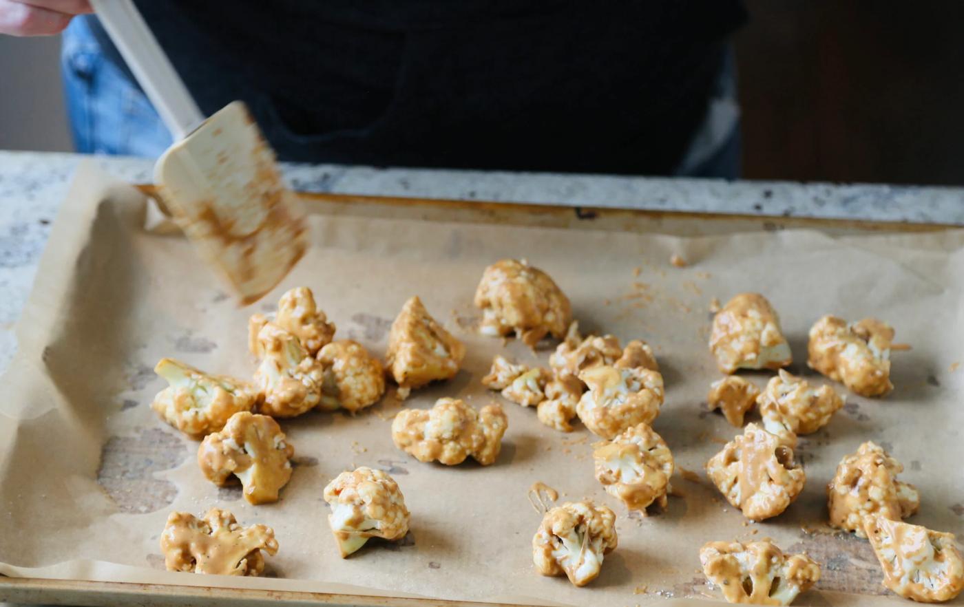 cauliflower florets on parchment lined sheet