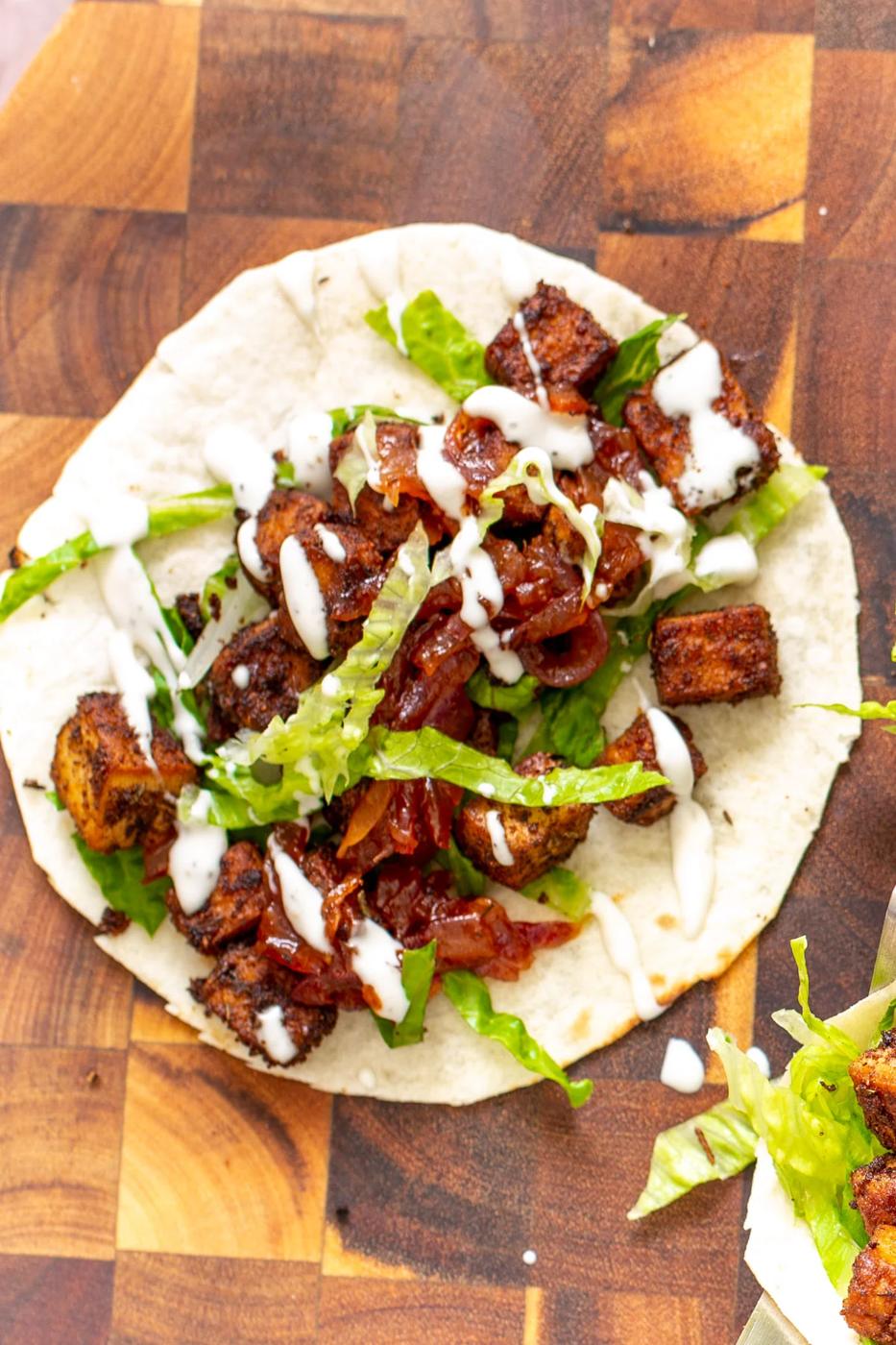 tortilla topped with blackened tofu, caramelized onion and sour cream