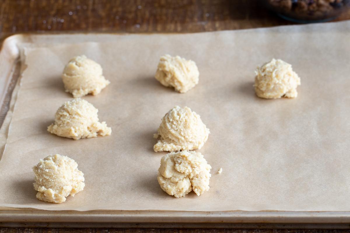 cookie dough balls on a baking sheet