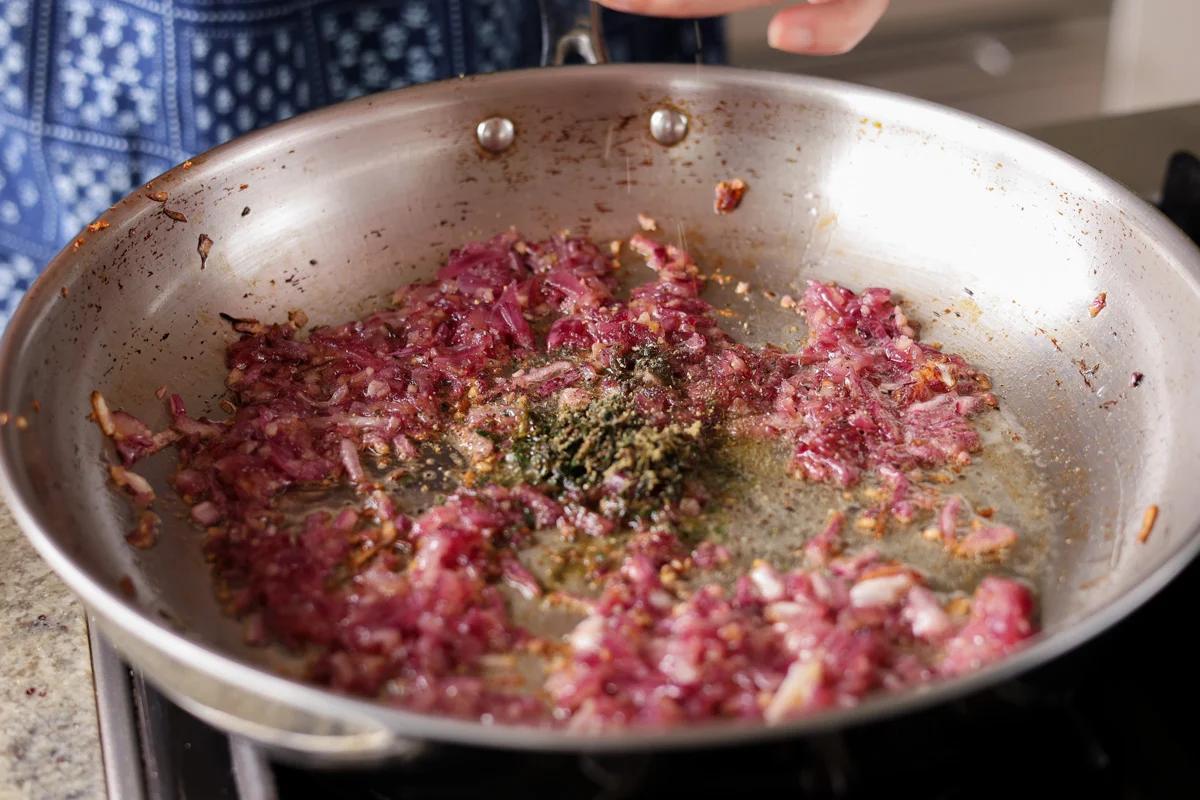 adding herbs to the pan