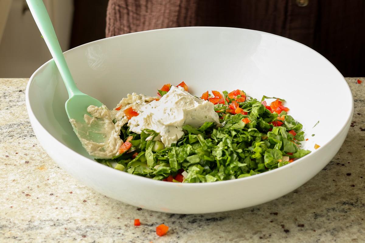 adding cream cheese and veggies to the tofu