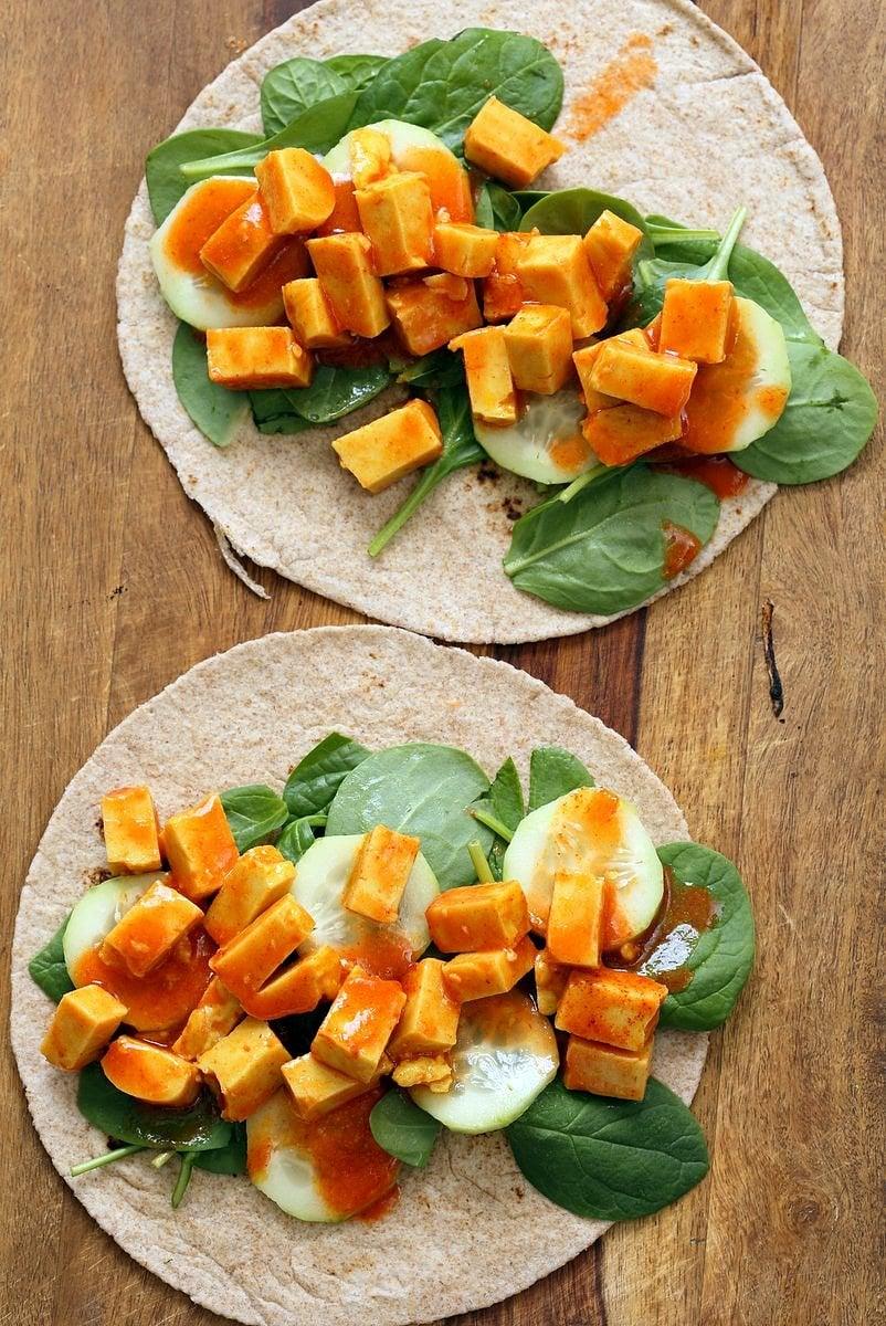 Buffalo Tofu wrap with Chickpea Tofu. Soy-free Chickpea flour Tofu tossed in buffalo hot sauce, layered with celery, spinach, cucumbers and vegan ranch. Easy weekday meal Recipe | VeganRicha.com