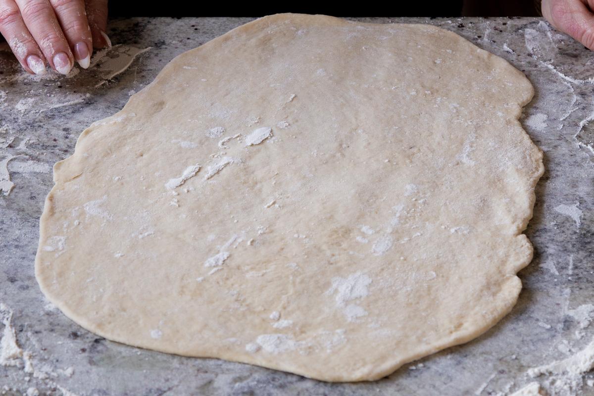 dough on a floured surface, after rolling it out