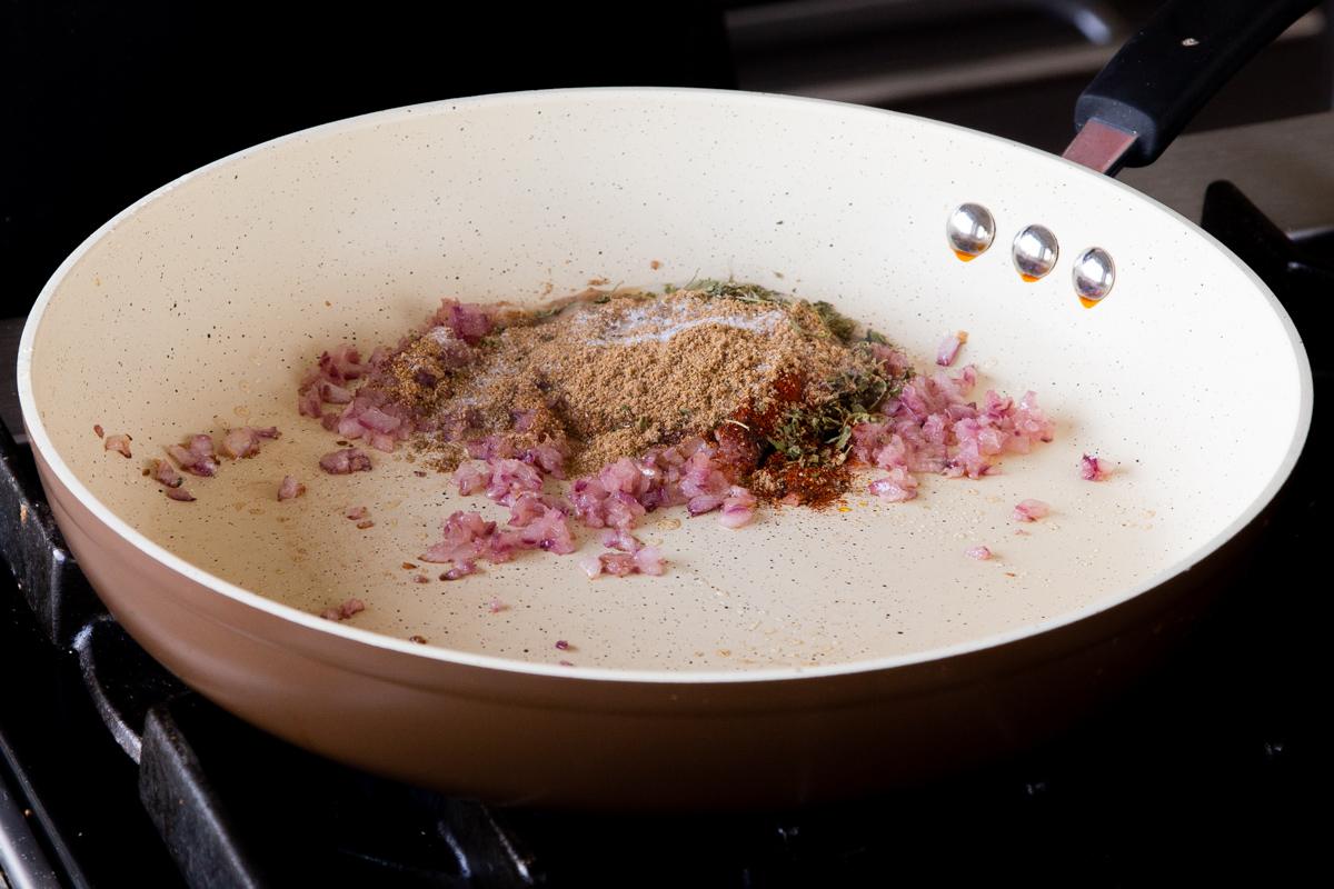 adding dried spices to the pan