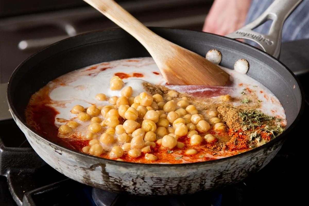 chickpeas in the skillet with the vegan butter chicken sauce ingredients