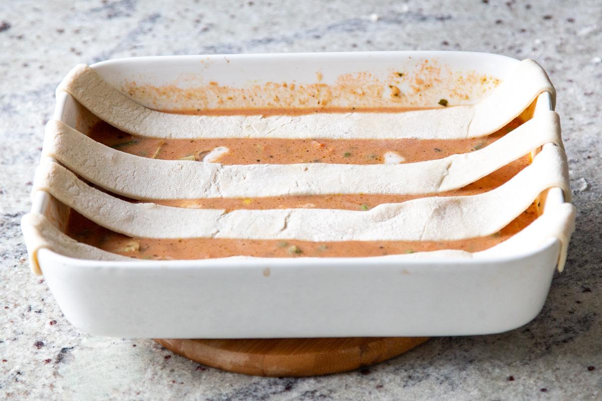 strips of puff pastry laid horizontally across the baking pan