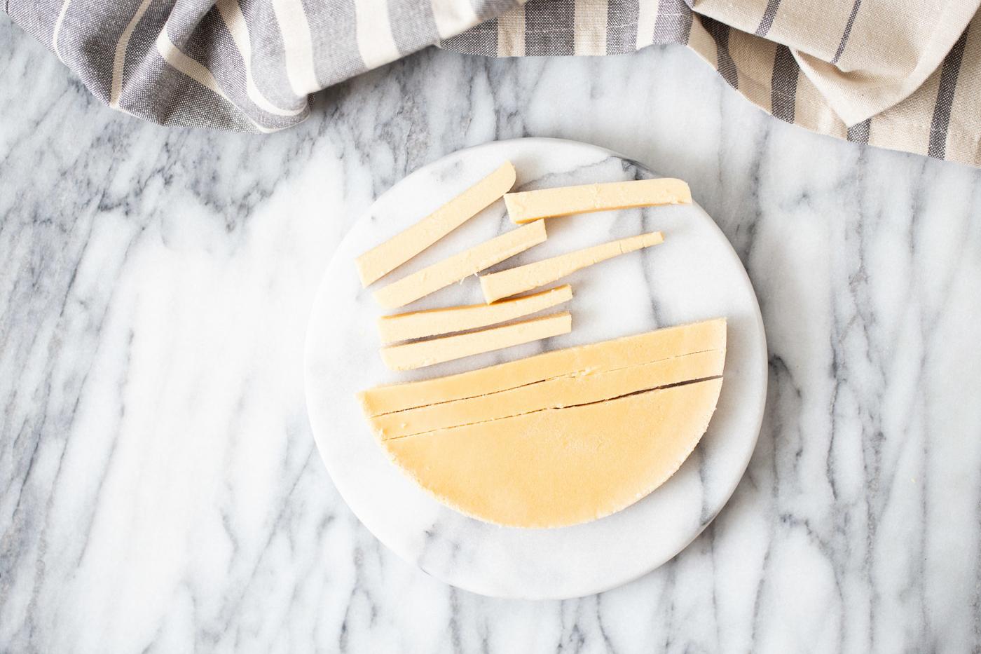 chilled chickpea flour batter being cut into fries