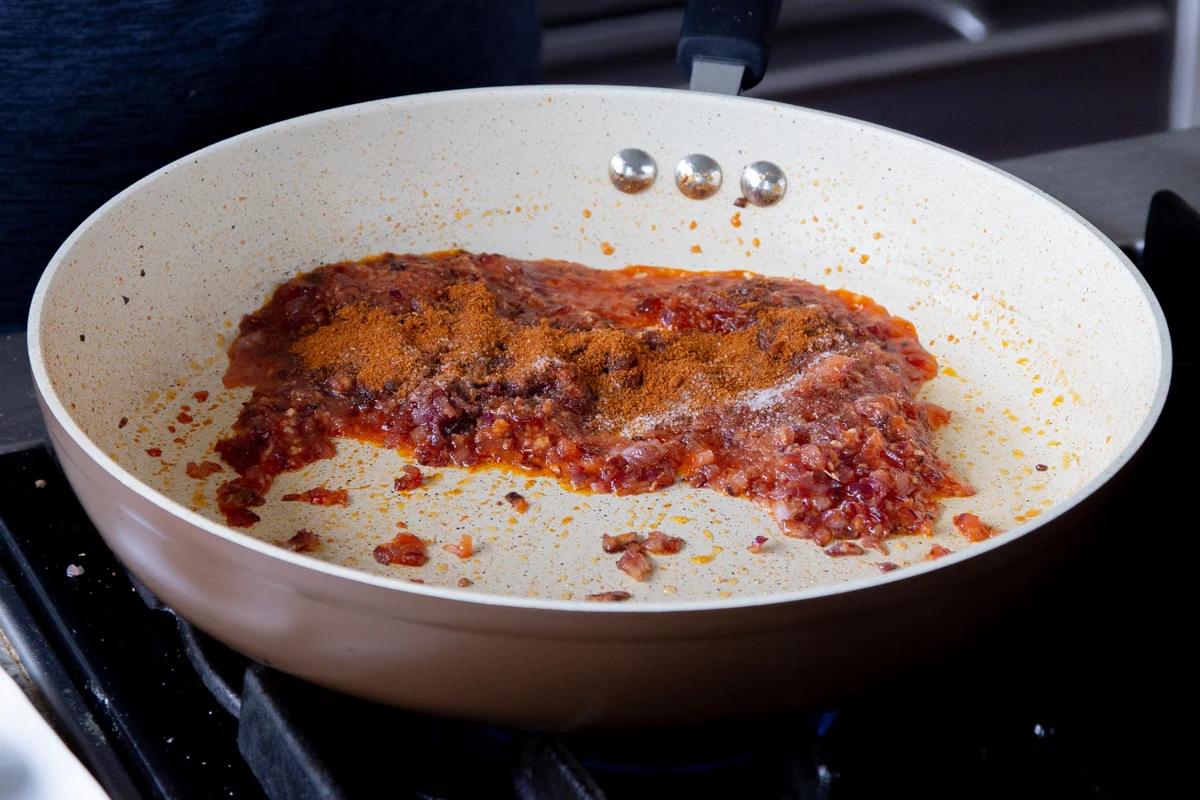 adding cajun spices to the cooked onion mixture