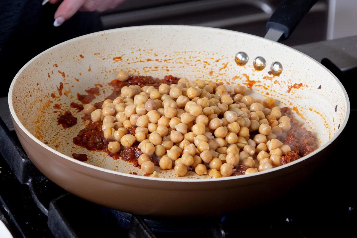 adding chickpeas to the pan