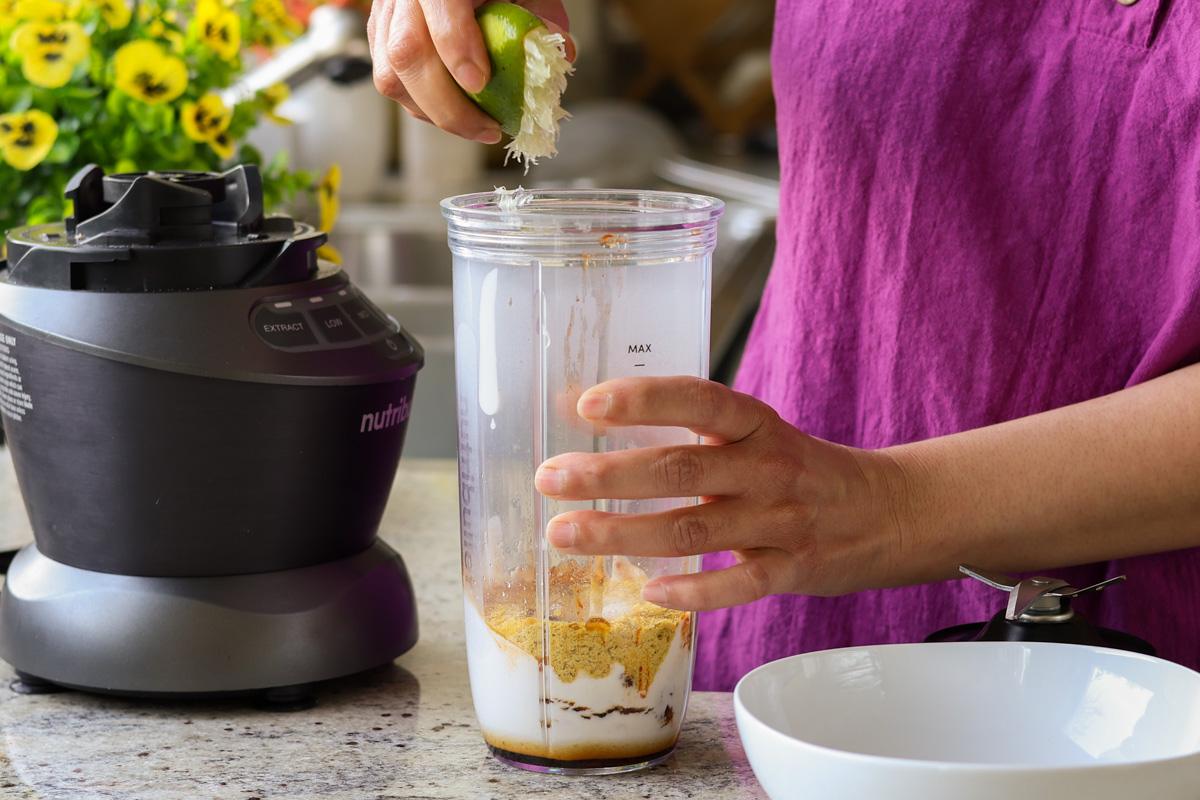 adding creamy chipotle lime dressing ingredients to the blender